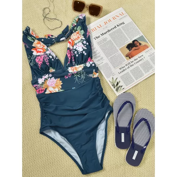 imageCUPSHE Women V Neck One Piece Swimsuit Halter Backless Ruched Tummy Control Bathing SuitNavy Yellow Floral